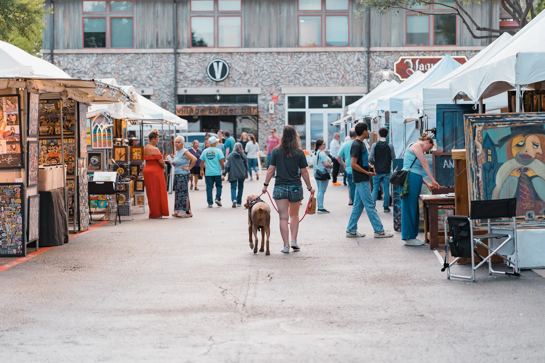 Festival-goers filling the street between rows of artist booths at Watters Creek